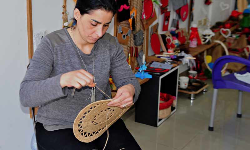 A woman folding making products from straw in Suwaida – July 3, 2019 (SANA)