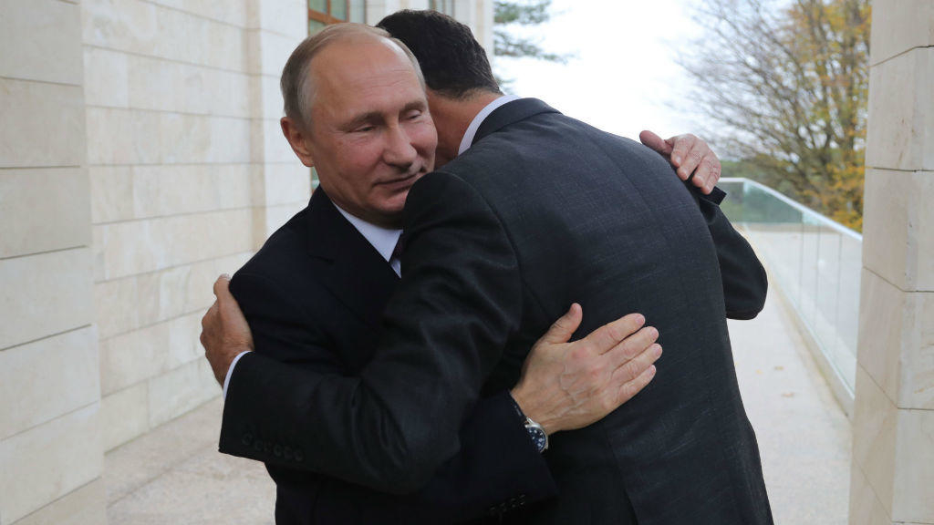 Russian President Vladimir Putin, left, embraces Syrian President Bashar Assad at the Bocharov Ruchei residence at the Black Sea resort of Sochi, Russia (Mikhail Klimentyev / AP)