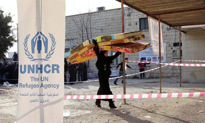 A Syrian refugee receiving aid from UNHCR in Lebanon- 2015 (Reuters)