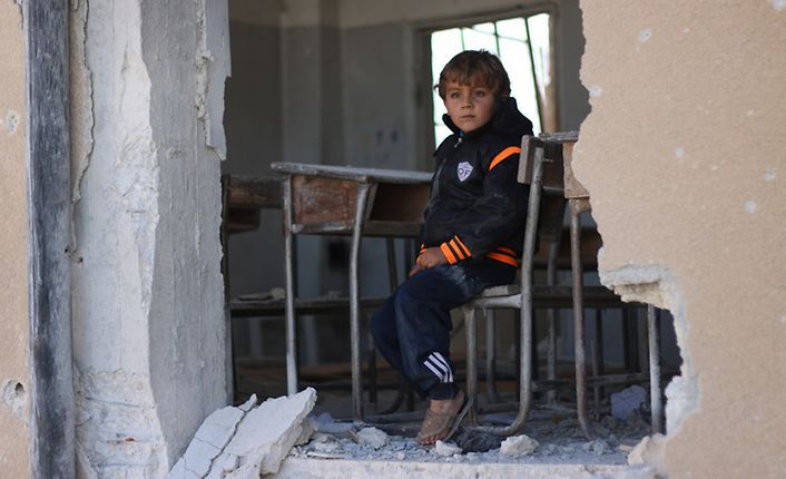 A child sitting in a destroyed school - 2016 (UNICEF)