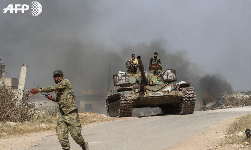 Combatants of the National Front for Liberation heading to participate in a battle in northern rural Hama – June 6, 2019 (Omar Haj Qadour-AFP)