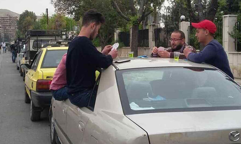 Young men playing cards while waiting in a gas filling queue in Damascus - April 16, 2019 (Diary of a Mortar Shell)