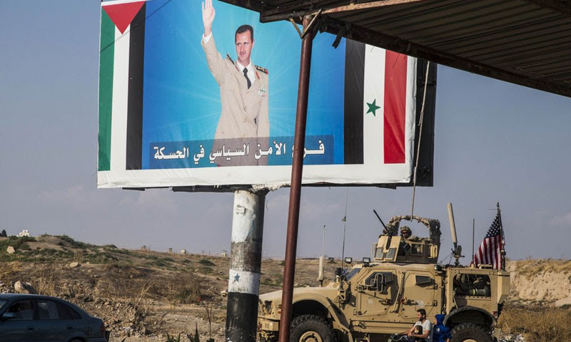 American armored vehicle in front of a photo of head of the Syrian regime, Bashar al-Assad, Qamishli Northern Syria, 26 November 2019