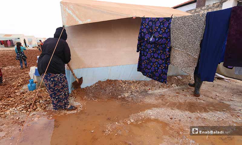 Al-Jasem tries to protect her tent by surrounding it with gravel to prevent water intrusion that kept her awake for two consecutive nights.