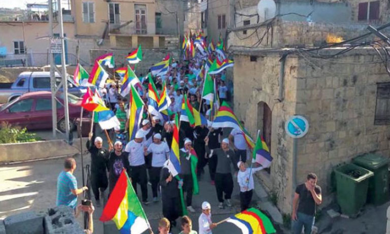 Demonstrators in As-Suwayda carrying Druze banners (Asharq al-Awsat newspaper)