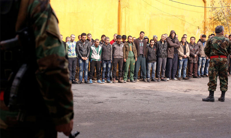 A number of young men from the eastern neighborhoods of Aleppo dragged to military service (Reuters)