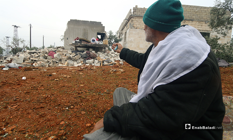 A man makes an appeal to God for mercy after his house was bombed in the town of Kafr Taal in the western countryside of Aleppo - 20 January 2020 (Enab Baladi)