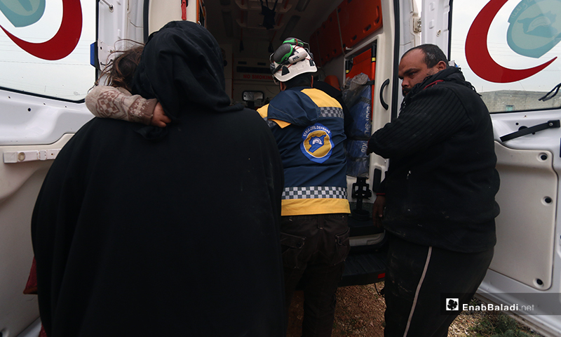Members of the Syrian Civil Defence (White Helmets) help children and a family that were injured by the bomb on the town of Kafr Taal in the western countryside of Aleppo - 20 January 2020 (Enab Baladi)