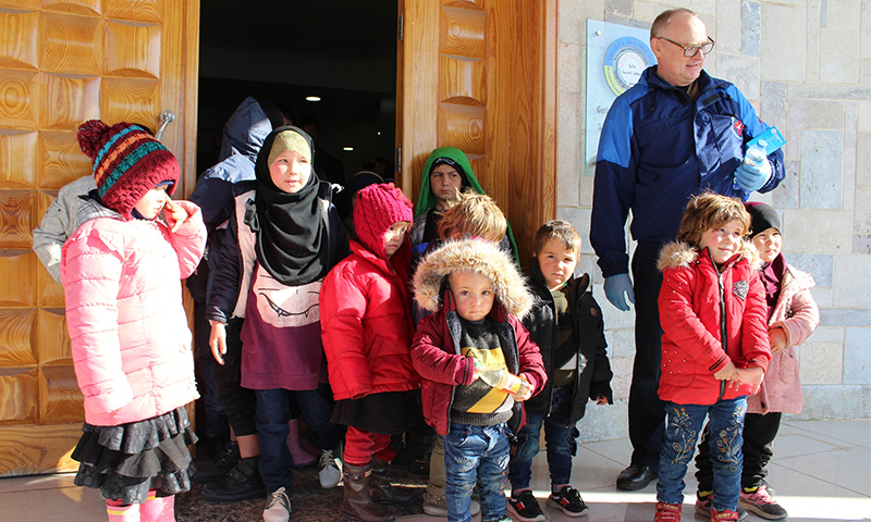 The Autonomous Administration handing over children from the orphans of al-Hawl camp ( the Autonomous Administration’s Facebook account )