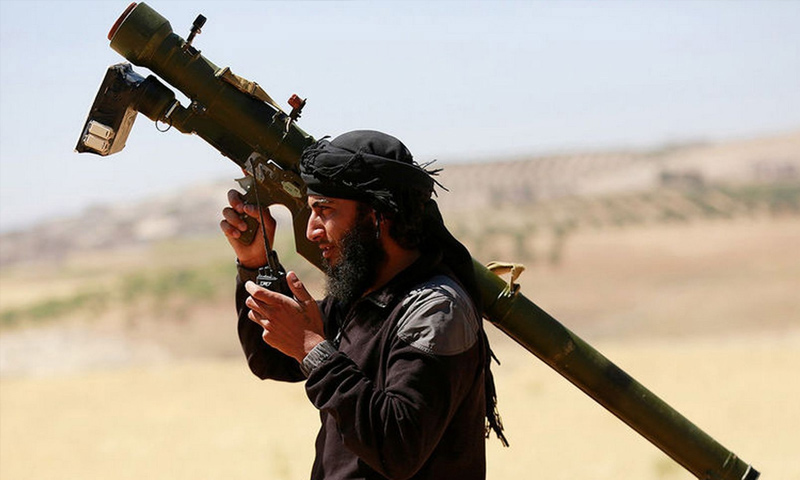 A fighter from the opposition factions holding a surface-to-air missile (Reuters)