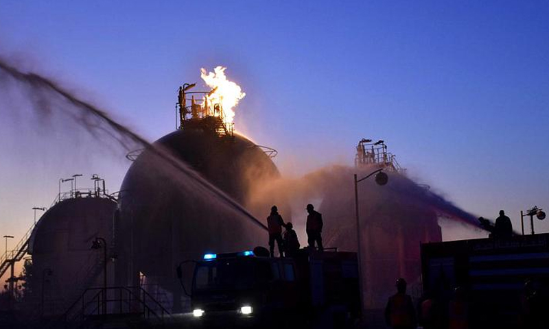 Fire fighters extinguishing a fire caused by bombing Oil installations in Homs – 21 December 2019 (SANA)