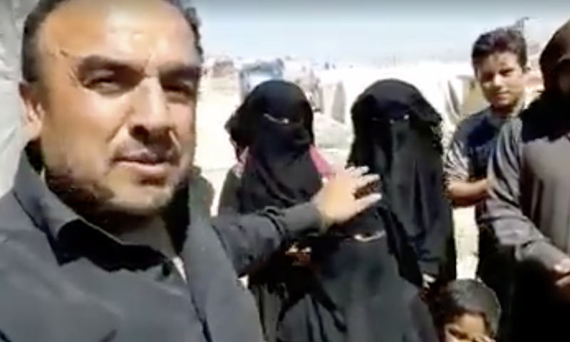 A man giving money rewards to Syrian girls for being veiled and asks a five-year-old child to wear a veil so that she can get a reward also - Idlib (Facebook activists' pages)