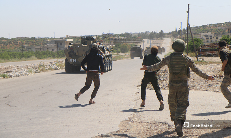 Sit-in protesters on the Aleppo – Lattakia international “M4” highway, throwing stones and pelting eggs at Russian military vehicles – 14 May 2020 (Enab Baladi)