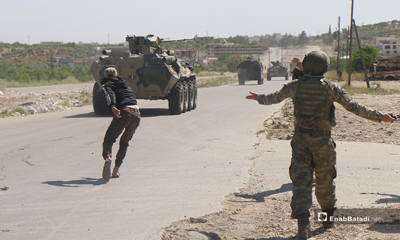 Sit-in protesters on the Aleppo – Lattakia international “M4” highway, throwing stones and pelting eggs at Russian military vehicles – 14 May 2020 (Enab Baladi)