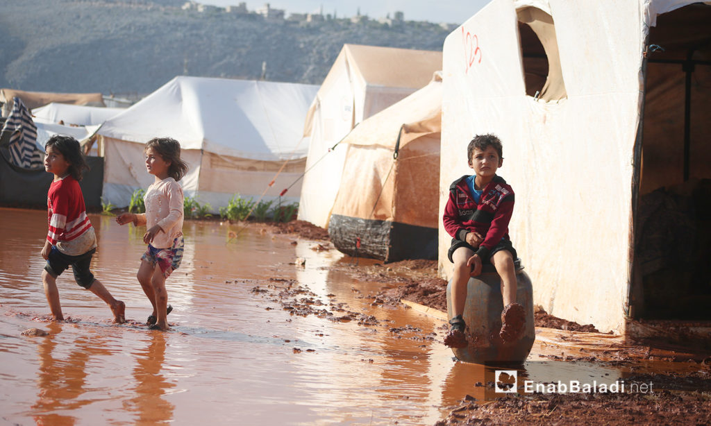 Children of “Sahl al-Khair” camp for Syrian internally displaced people (IDPs) after the rainstorm near Kafr Bunni in northern Idlib countryside – 19 June 2020 (Enab Baladi / Yousef Ghuraibi)