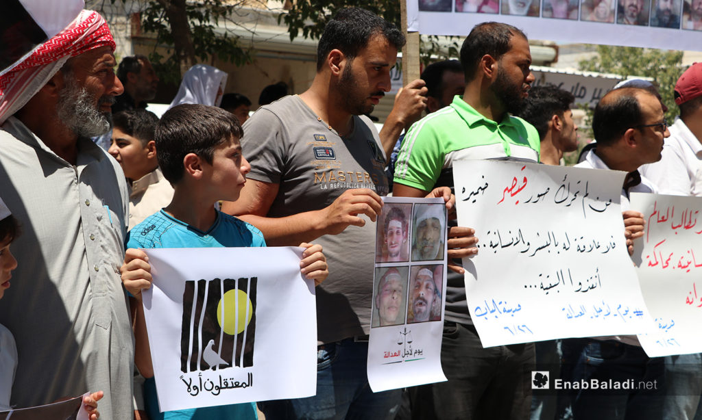 The residents of al-Bab city of eastern Aleppo organize a protest stand in solidarity with Syrian detainees under the slogan “Day for Justice”– 26 June 2020 (Enab Baladi / Asim Melhem)