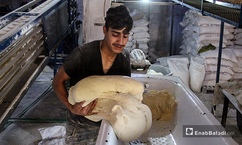 A worker in one of the bakeries of Kafr Aruq village in northern Idlib – 09 June 2020 (Enab Baladi – Iyad Abd al-Jawad)
