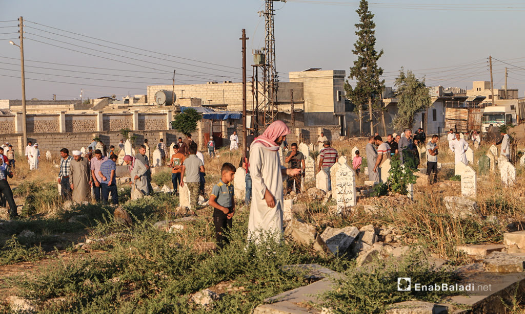 The residents of Dabiq town in northern Aleppo countryside visiting their relatives’ graves in the first day of Eid al-Adha – 31 July 2020 (Enab Baladi / Abdul Salam Majan)