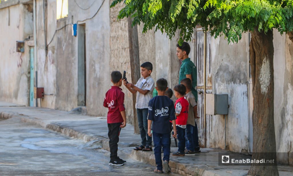 Children in front of their house celebrating the first day of Eid al-Adha in Dabiq town in northern Aleppo countryside – 31 July 2020 (Enab Baladi / Abdul Salam Majan)