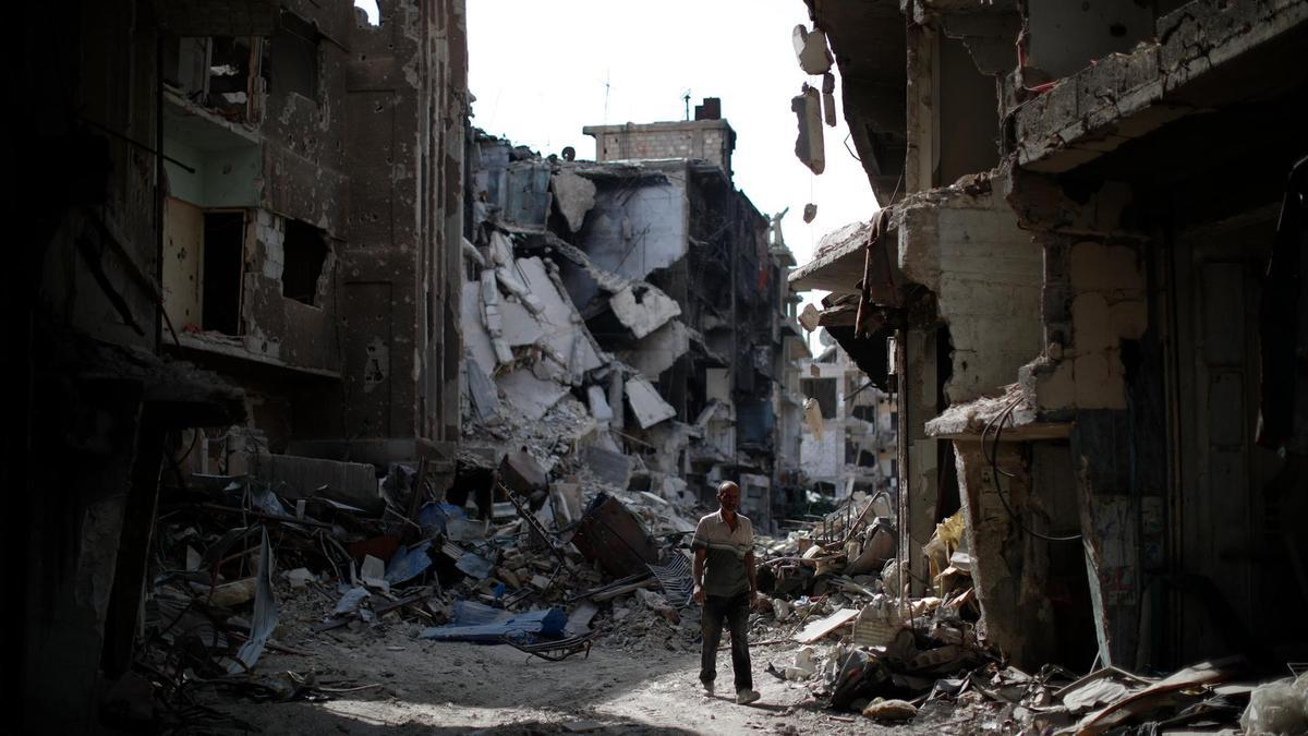 A man walking through the rubble in the Yarmouk camp for Palestinian refugees in Damascus – 6 October, 2018 (AP)