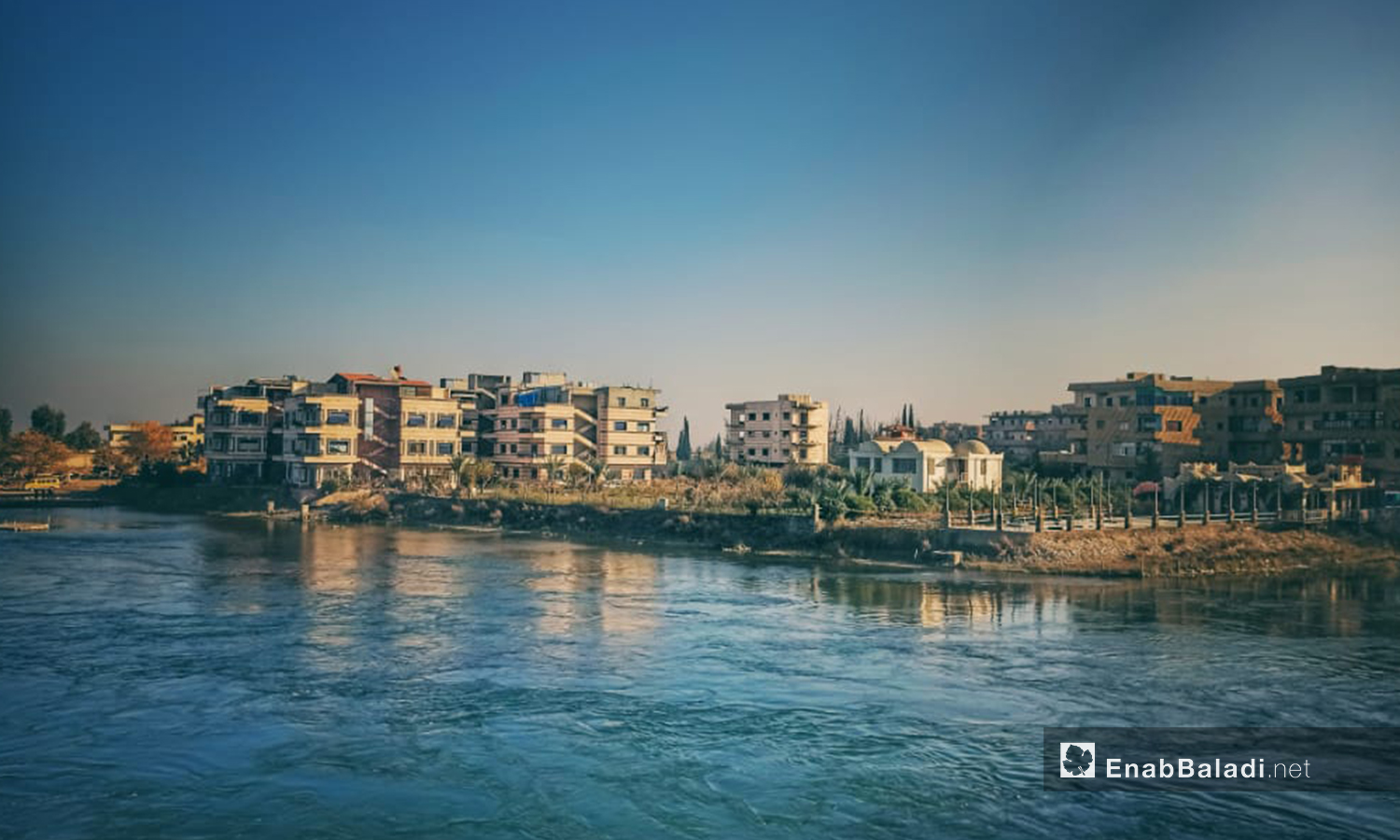 Residential buildings overlooking the Euphrates River in al-Raqqa city, northern Syria - 09 July 2020 (Enab Baladi)