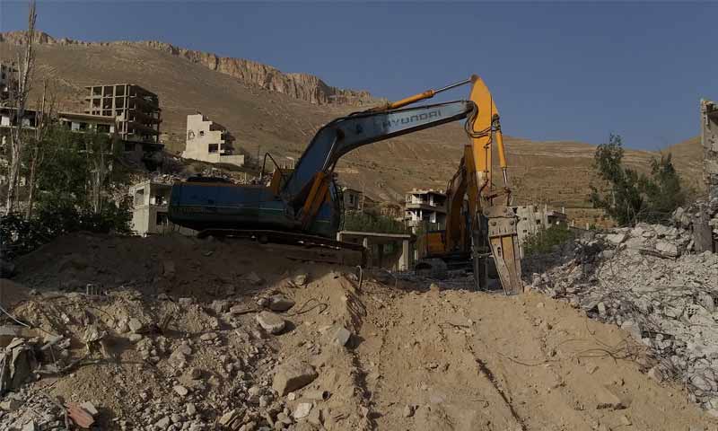 The removal of rubble around the tunnel of the Ain al-Fijeh Spring (The Syrian Prime Ministry's Facebook account)