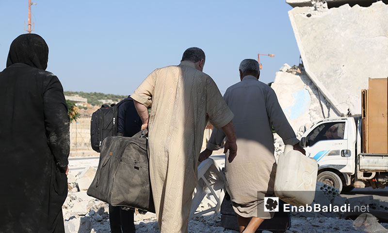 Syrian internally displaced persons moving the furniture of their destroyed houses in southern Idlib countryside during the relative calmness in the area - 06 September 2019 (Enab Baladi)