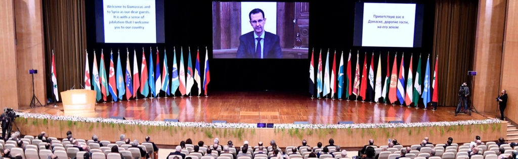The head of the Syrian Regime addresses the audience via a video call due to the spread of "Covid-19" during the “refugees return" conference in the Syrian capital, Damascus under the supervision and organization of Russia - 11 November 2020 (Syrian News Agency "SANA")