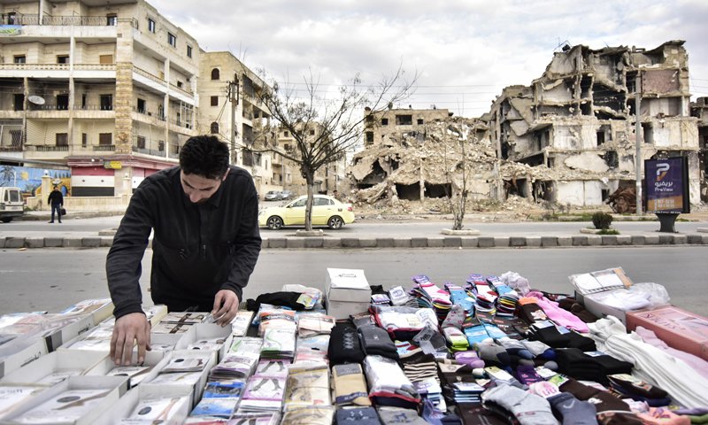 A Socks selling stall in front of a destroyed building in the Saif al-Dawla neighborhood in Aleppo city - March 2020 (Sputnik agency)