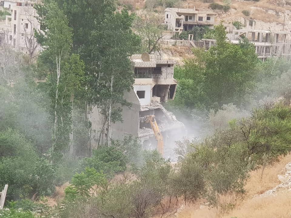 The Syrian regime’s machinery demolishing story buildings on the bank of the Barada River in Ain al-Fijeh in Rif Dimashq governorate - 7 June 2019 (the General Housing Establishment)