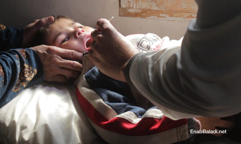 A male doctor examining a child in the health center of al-Fardan in the northern countryside of Idlib- February 2021 (Enab Baladi – Iyad Abdul Jawad))