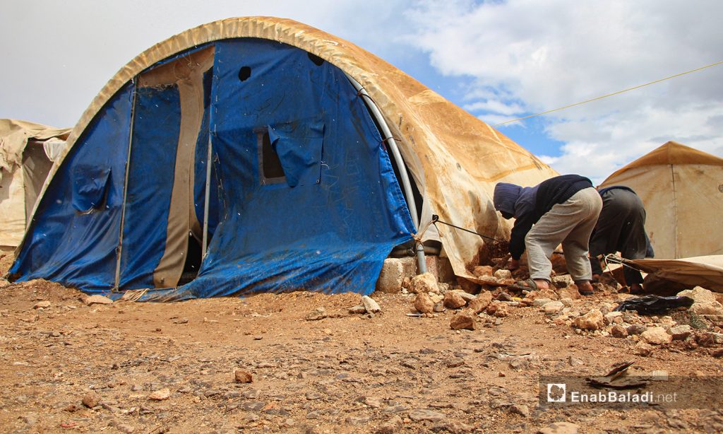 A storm with heavy rain hit the camps for internally displaced people (IDPs) in the northern countryside of Idlib, uprooting the already worn-out tents —24 March 2021 (Enab Baladi / Iyad Abdul Jawad)