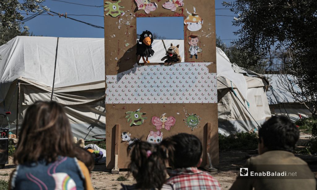 A puppet show staged by al-Harah theater group in one of the camps for internally displaced people (IDPs) near Idlib city - 28 March 2021 (Enab Baladi / Yousef Ghuraibi)