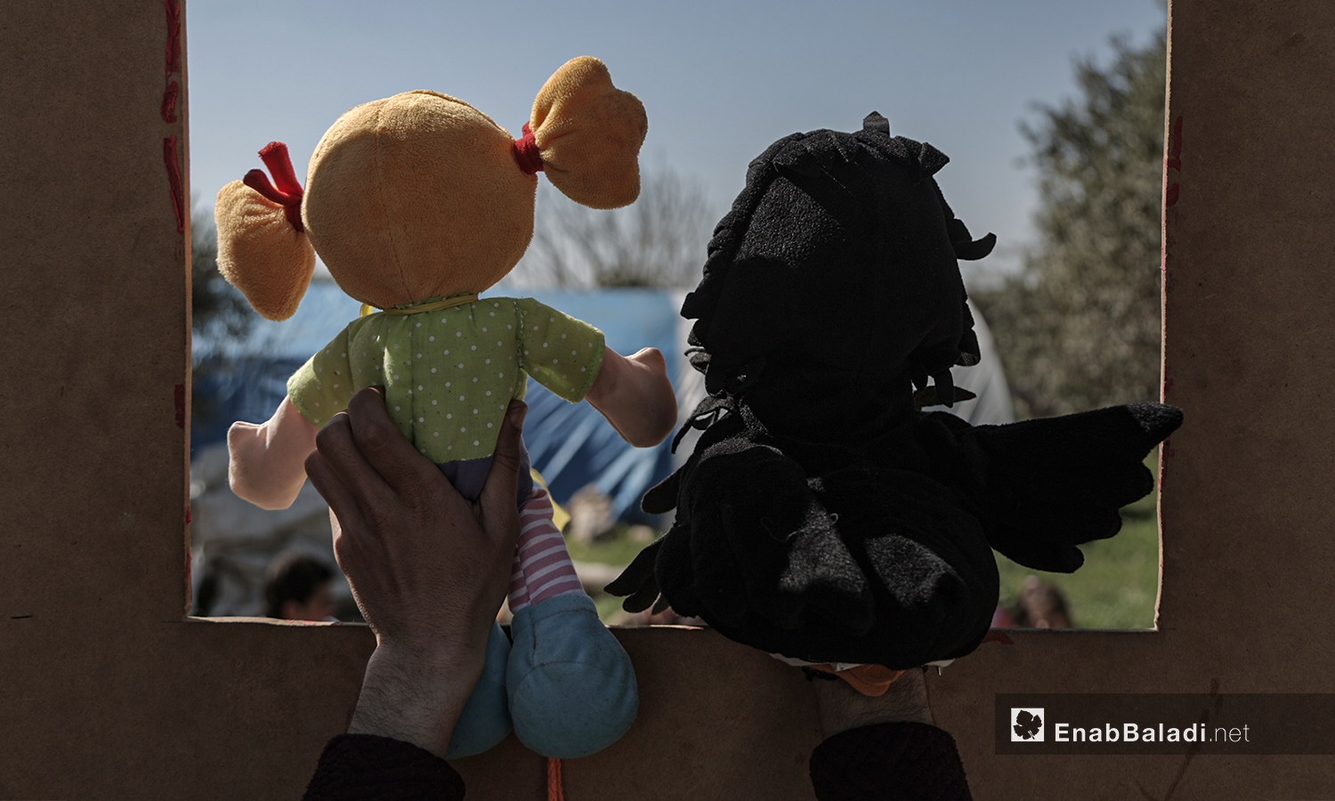 A puppet show staged by al-Harah theater group in one of the camps for internally displaced people (IDPs) near Idlib city - 28 March 2021 (Enab Baladi / Yousef Ghuraibi)

