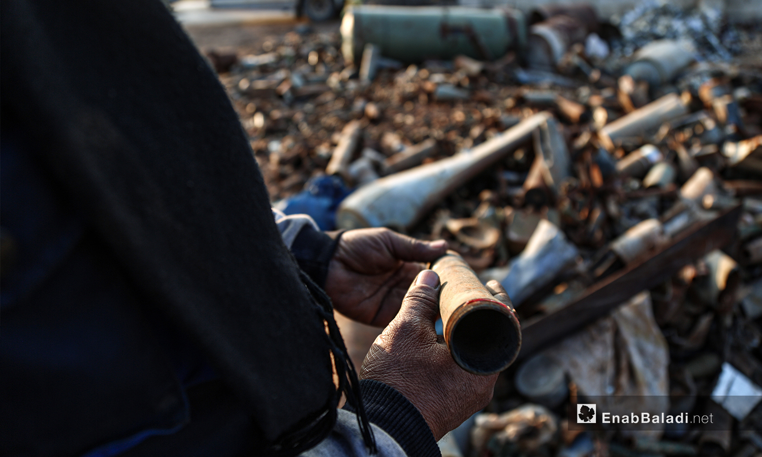 Abu Ahmad said when dismantling unexploded ordnance in the northern countryside of Idlib; he uses primitive tools such as a chisel, a hammer, and a ranch key - 5 March 2021 (Enab Baladi / Youssef Gharibi)