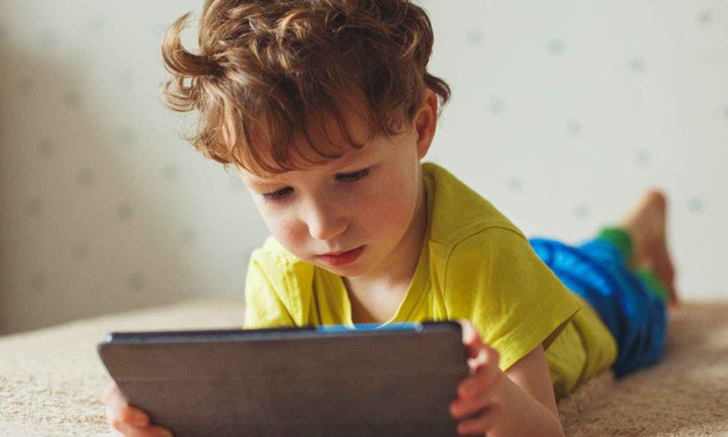 A child playing on an iPad (CNN)