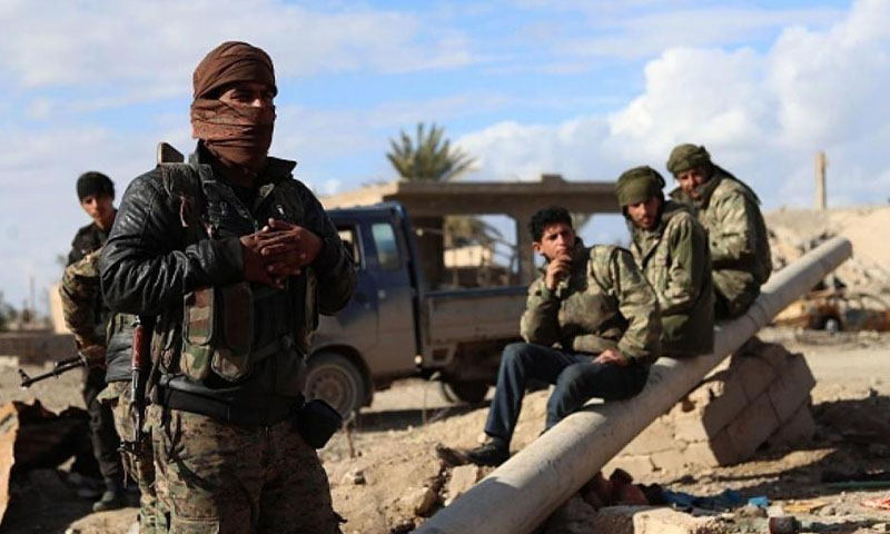 Fighters from the Syrian Democratic Forces (SDF) stationed in al-Baghouz town in Deir Ezzor governorate (AFP)