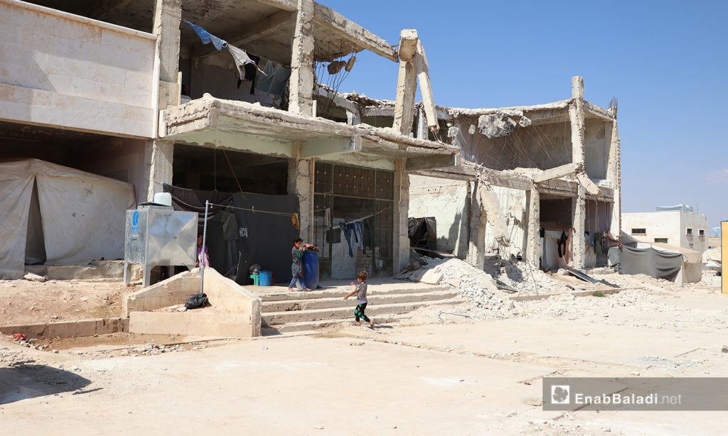 A displaced family found a shelter in a demolished building in the camp of Qibtan, near the town of Akhtarian in the northern countryside of Aleppo- 17 July 2020 (Enab Baladi- Assim al-Mulhem)