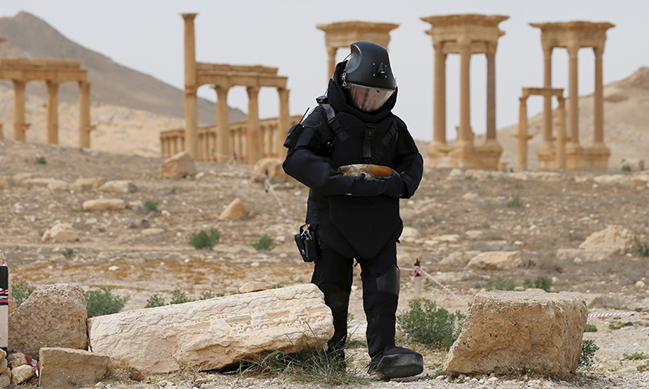 Russian explosives specialist clearing mines from the ancient city of Palmyra in Syria (Reuters)