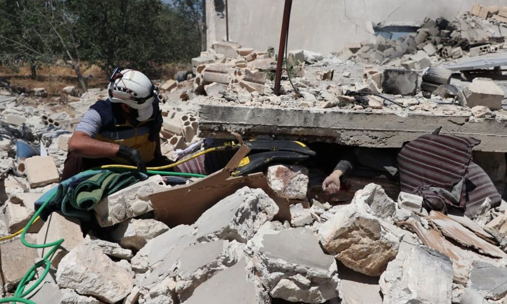 A Syrian Civil Defence member attempting to save a civilian from under the rubble of his home, south of Idlib - 6 June 2021 (Syrian Civil Defence)