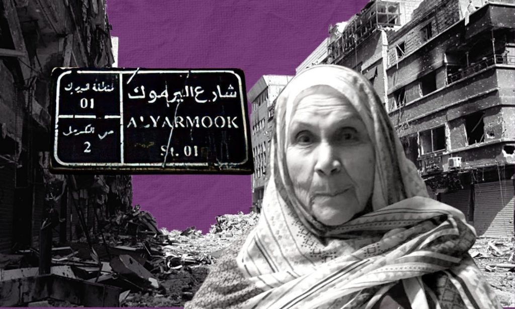 A displaced woman from the Yarmouk camp to the south of the Syrian capital Damascus with destroyed buildings behind her. A street name sign could also be seen with the name of Yarmouk Street, one of the Yarmouk camp streets (edited by Enab Baladi)