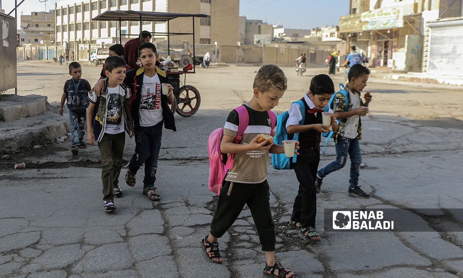 Primary school pupils having bread and salep on their way to school in the morning with the start of the new school year in the northern countryside of Aleppo- Azaz- 22 September 2021(Enab Baladi-Walid Othman)
