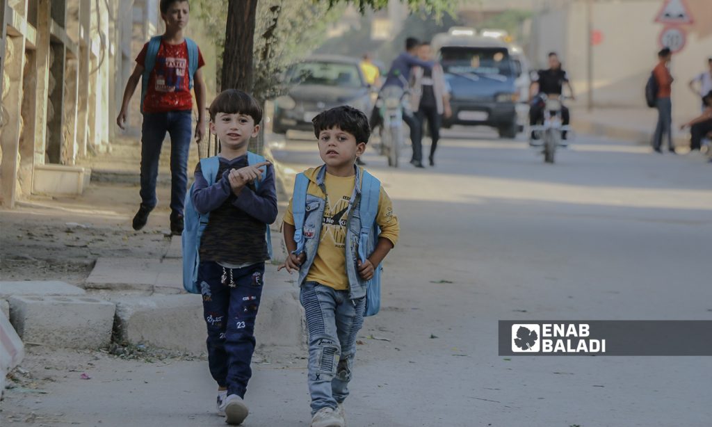 Two primary school students go to school in the morning at the beginning of the new school year in the northern countryside of Aleppo - Azaz city - 22 September 2021 (Enab Baladi / Walid Othman)