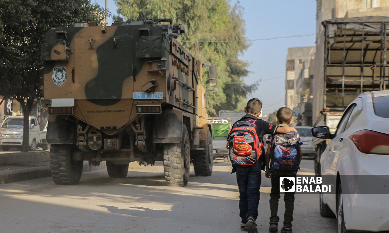 Two primary school students go to school in the morning at the beginning of the new school year in the northern countryside of Aleppo - Azaz city - 22 September 2021 (Enab Baladi / Walid Othman)
