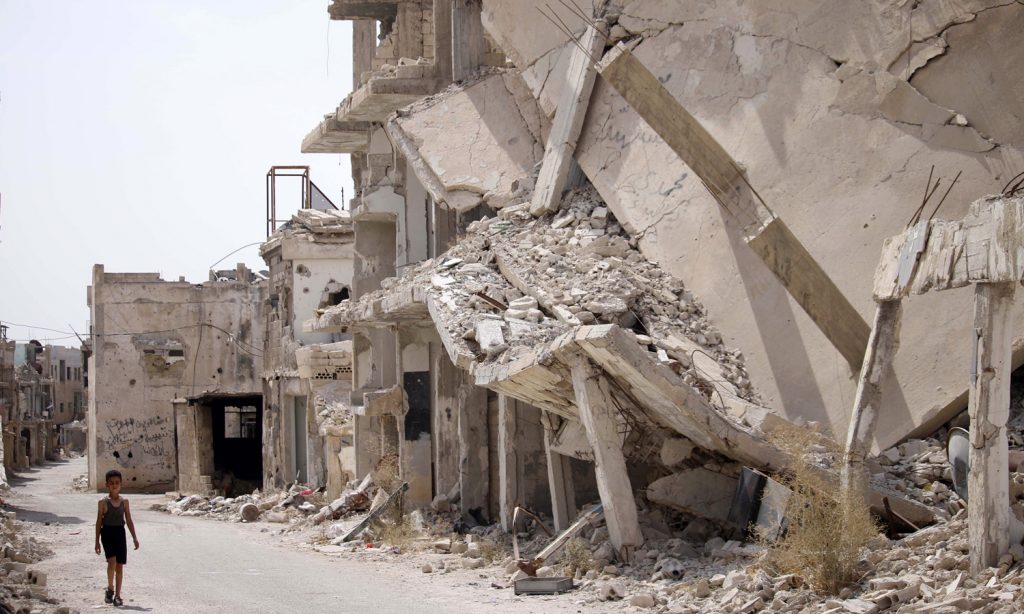 A Syrian child walking past the rubble of destroyed buildings in Daraa, southern Syria- 2 October 2019(AFP)