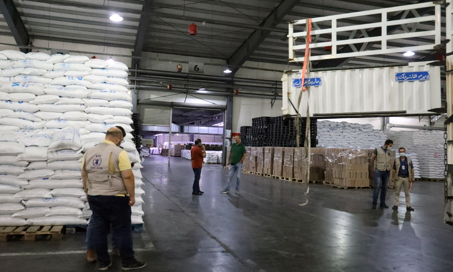 Workers at the World Food Programme (WFP) loading trucks with relief assistance to be delivered from regime areas to northwestern Syria - 30 August 2021 (Twitter)