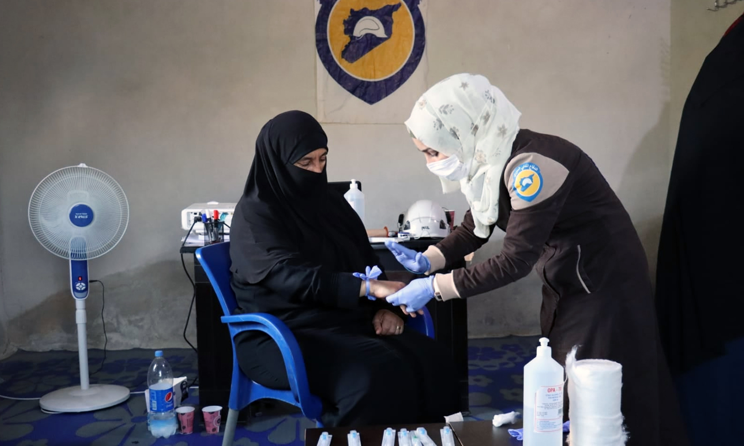 A volunteer at the Syria Civil Defence Team (SCD) training “Umm Mohammed” from the al-Ghab Plain during a course titled “A Paramedic in Every Home” (Syria Civil Defence)