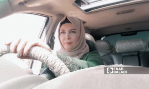 The founder of the Mazaya Center for Women in Idlib, Ghalia al-Rahal, driving her car in Idlib (Enab Baladi)