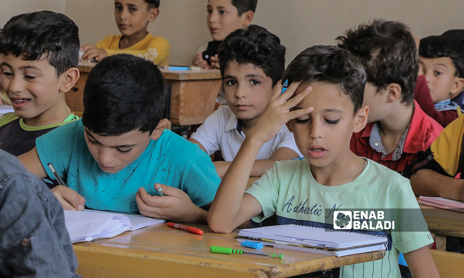 Primary school students sitting at desks in a classroom at the beginning of the new school year in the northern countryside of Aleppo - Azaz city - 22 September 2021 (Enab Baladi / Walid Othman)