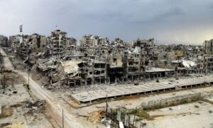 Destroyed buildings in Homs city after the end of fighting between the armed opposition and Syrian regime-affiliated forces (Reuters)
